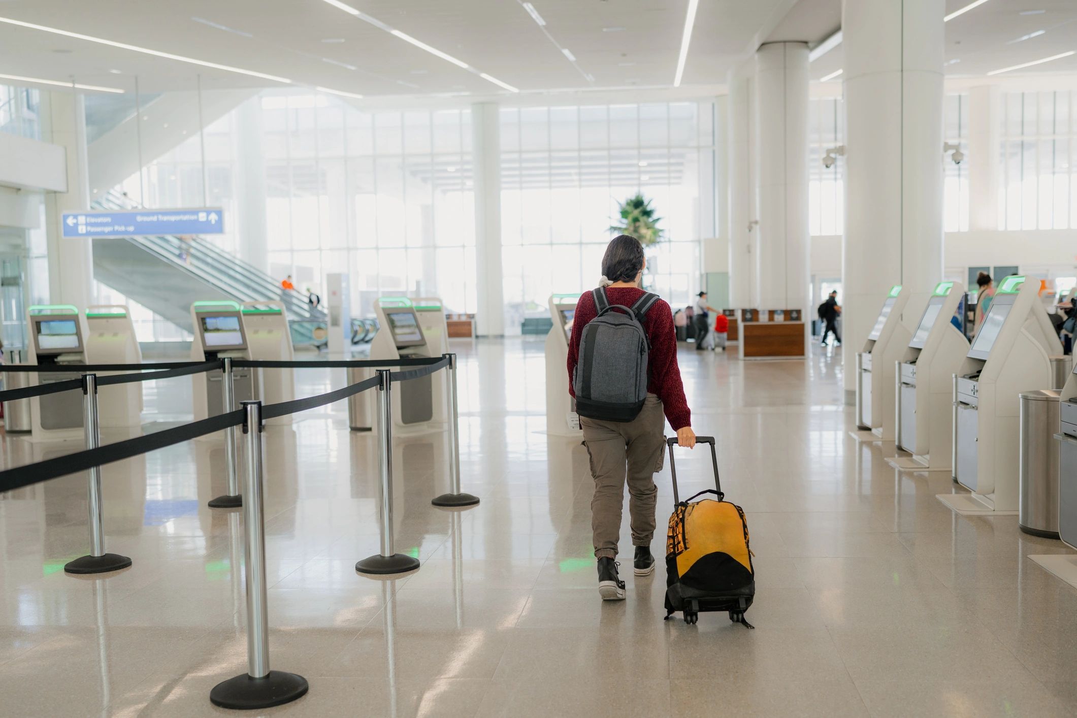 Business traveler walking through airport terminal